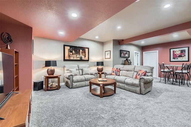 carpeted living room featuring a textured ceiling