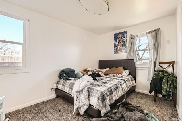 carpeted bedroom featuring baseboards