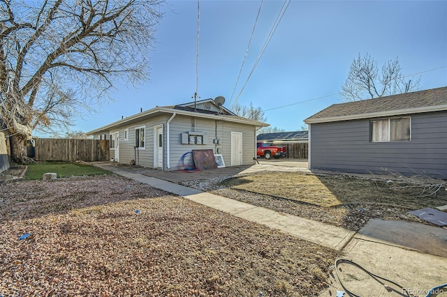 back of house featuring fence