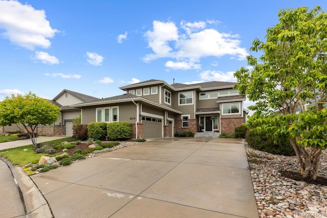 prairie-style home with driveway and brick siding
