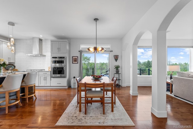 dining space featuring healthy amount of natural light, wood finished floors, a chandelier, and recessed lighting