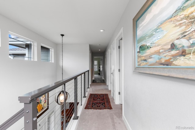 corridor with light colored carpet, recessed lighting, and baseboards