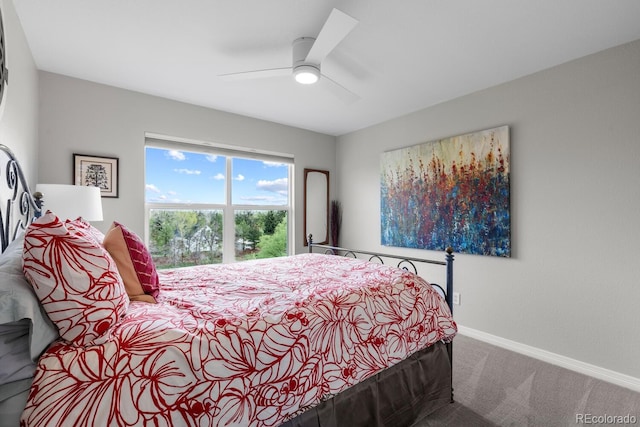 carpeted bedroom featuring baseboards and ceiling fan