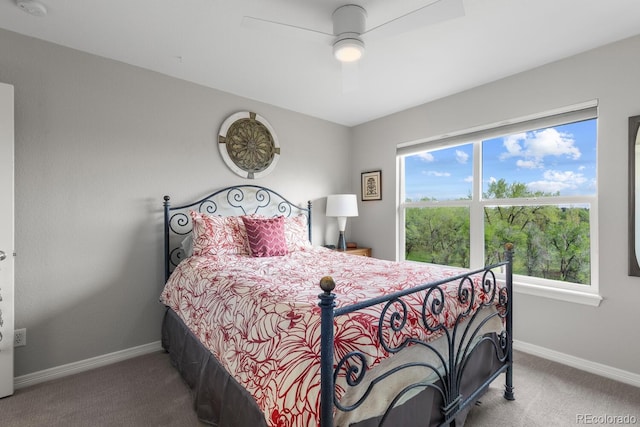 carpeted bedroom featuring baseboards and ceiling fan