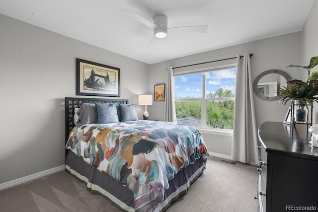 carpeted bedroom with baseboards and a ceiling fan