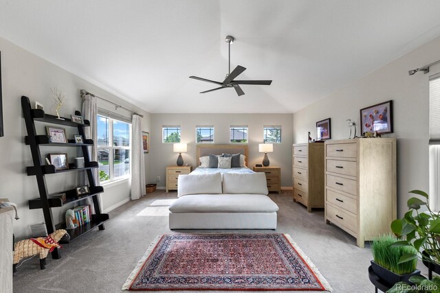 bedroom with light carpet and a ceiling fan