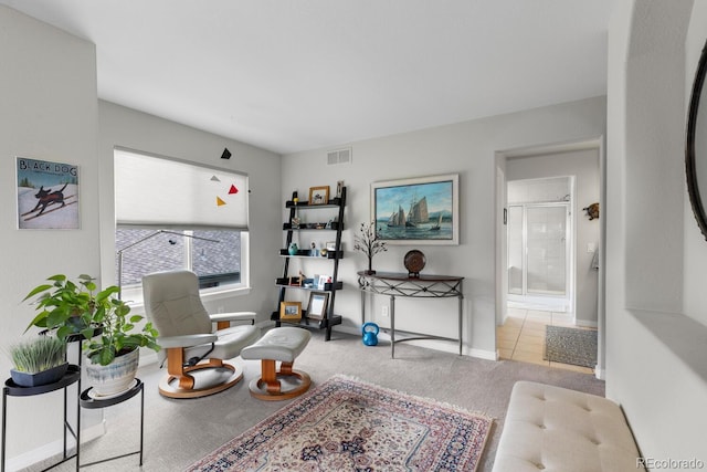 living area featuring carpet and baseboards