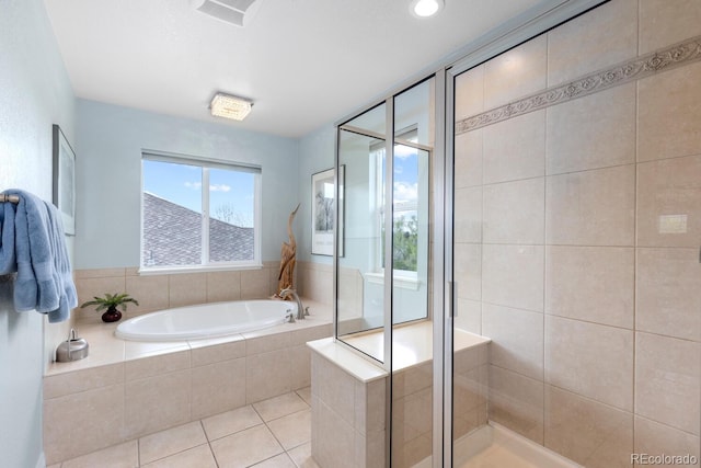 full bath featuring a shower stall, a garden tub, and tile patterned floors
