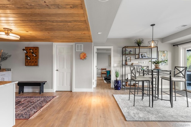dining space featuring light wood-style floors, baseboards, and recessed lighting