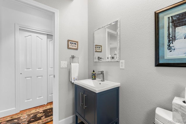 bathroom featuring toilet and vanity