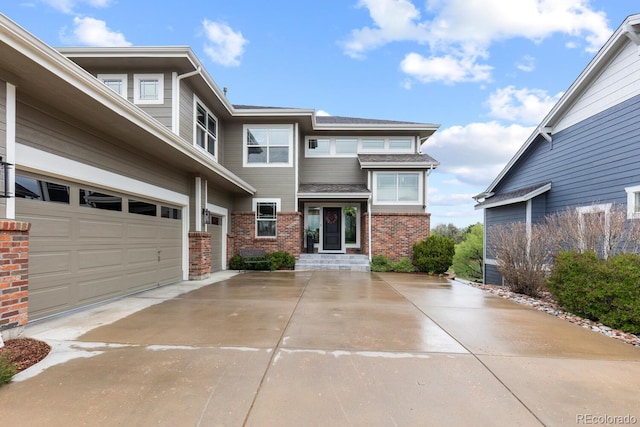 view of front of home with driveway and brick siding