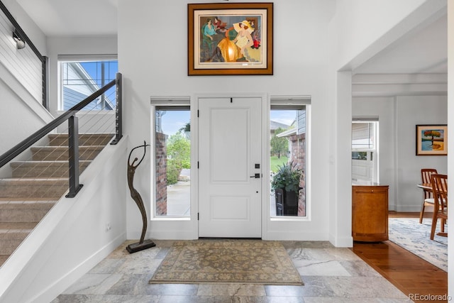 5319 W Hoover Dr, Littleton, CO 80123 - entrance foyer with healthy amount of natural light, stone tile flooring, and stairs