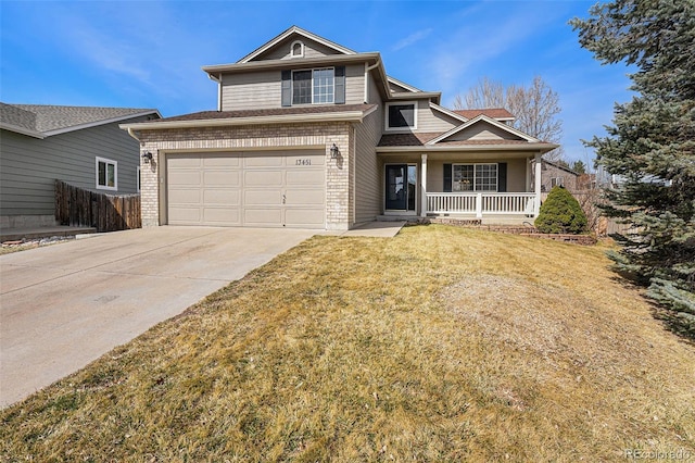 traditional-style house with a front lawn, driveway, fence, covered porch, and brick siding