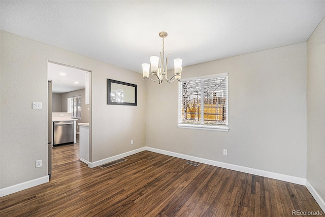 empty room with dark wood-type flooring, baseboards, and visible vents