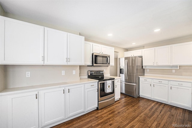 kitchen featuring recessed lighting, stainless steel appliances, dark wood-type flooring, white cabinets, and light countertops