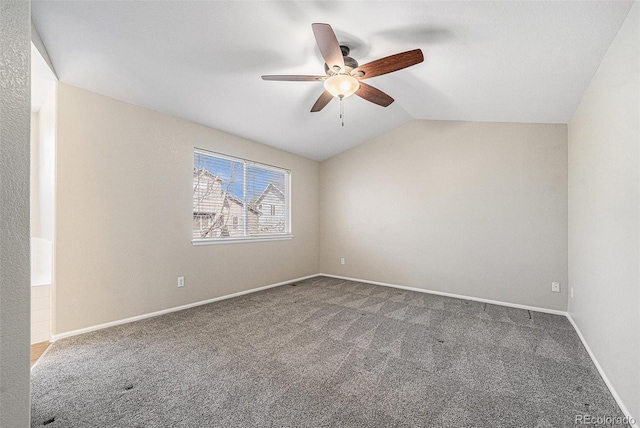 carpeted empty room with ceiling fan, baseboards, and lofted ceiling