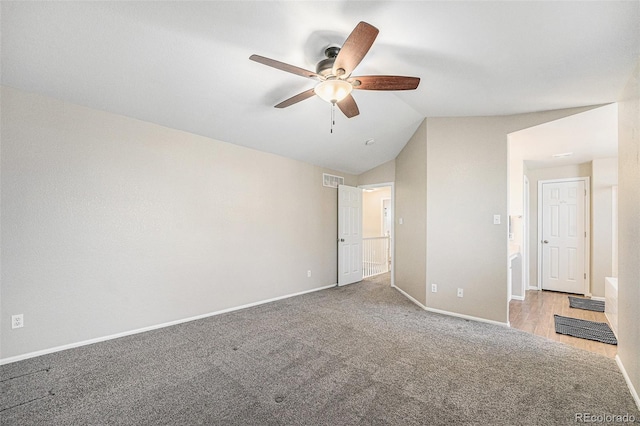 unfurnished bedroom with visible vents, ceiling fan, baseboards, carpet floors, and vaulted ceiling