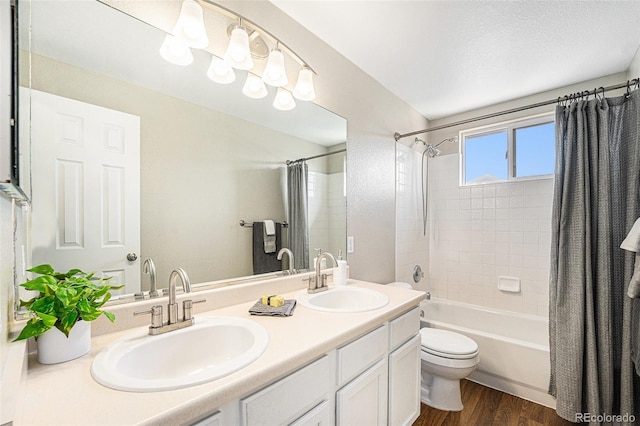 full bath with double vanity, wood finished floors, shower / tub combo with curtain, and a sink