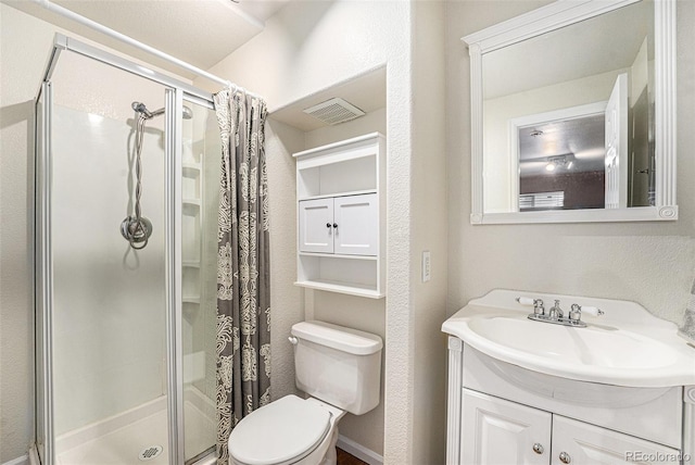 bathroom with vanity, visible vents, a shower stall, toilet, and a textured wall