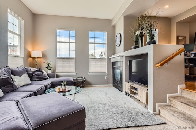 9424 Ridgeline Blvd, Highlands Ranch, CO 80129 - living area with healthy amount of natural light, carpet, and a glass covered fireplace