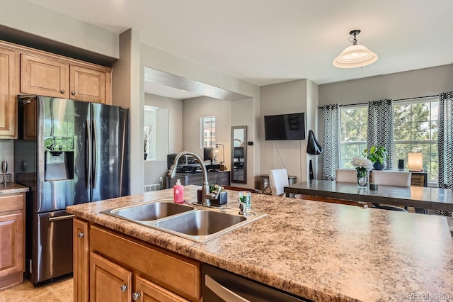 9424 Ridgeline Blvd, Highlands Ranch, CO 80129 - kitchen featuring stainless steel appliances, decorative light fixtures, light countertops, and brown cabinets
