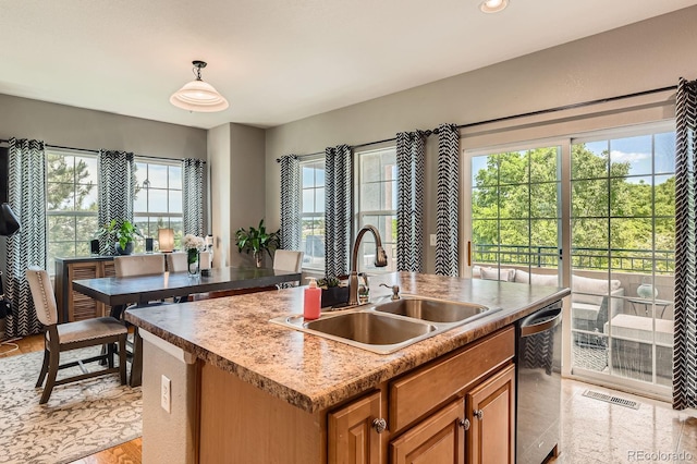 9424 Ridgeline Blvd, Highlands Ranch, CO 80129 - kitchen featuring stainless steel dishwasher, healthy amount of natural light, a center island with sink, brown cabinets, and recessed lighting