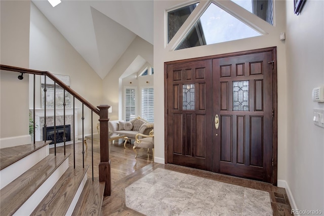 foyer entrance featuring high vaulted ceiling