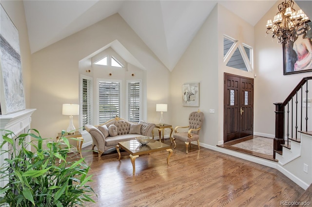 entrance foyer featuring a chandelier, hardwood / wood-style floors, and high vaulted ceiling