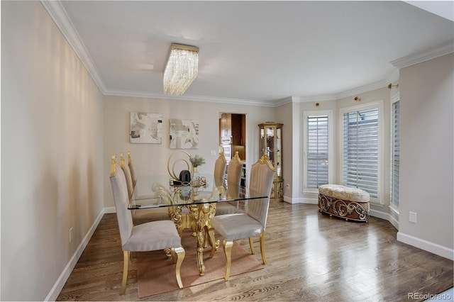 dining area featuring crown molding and hardwood / wood-style flooring