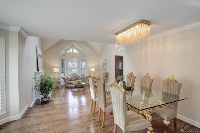 dining room with an inviting chandelier, wood-type flooring, and ornamental molding