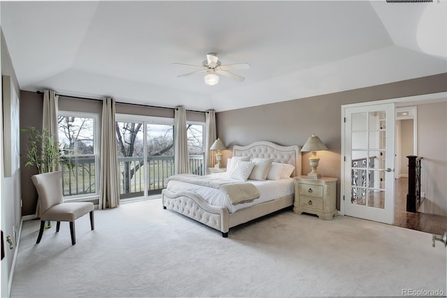 bedroom featuring light colored carpet, lofted ceiling, multiple windows, and access to outside