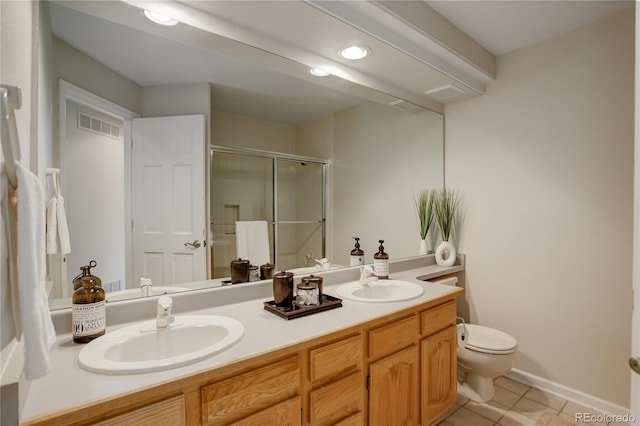 bathroom featuring vanity, tile patterned flooring, a shower with shower door, and toilet