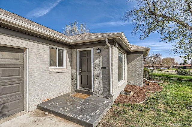 3075 Fairfax St, Denver, CO 80207 - view of exterior entry with brick siding and a garage