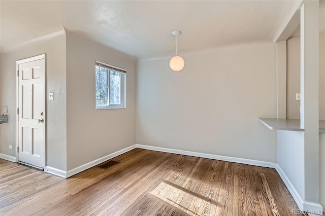 3075 Fairfax St, Denver, CO 80207 - unfurnished dining area featuring baseboards, wood finished floors, and visible vents