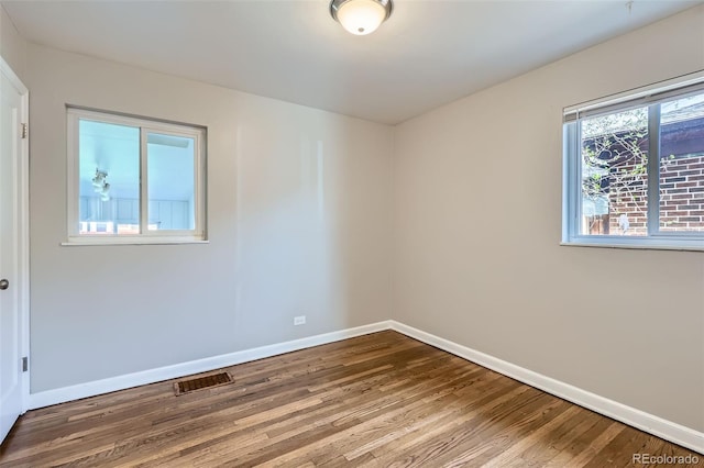 3075 Fairfax St, Denver, CO 80207 - spare room featuring wood finished floors, visible vents, and baseboards
