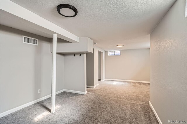 3075 Fairfax St, Denver, CO 80207 - basement featuring a textured ceiling, visible vents, carpet flooring, and baseboards