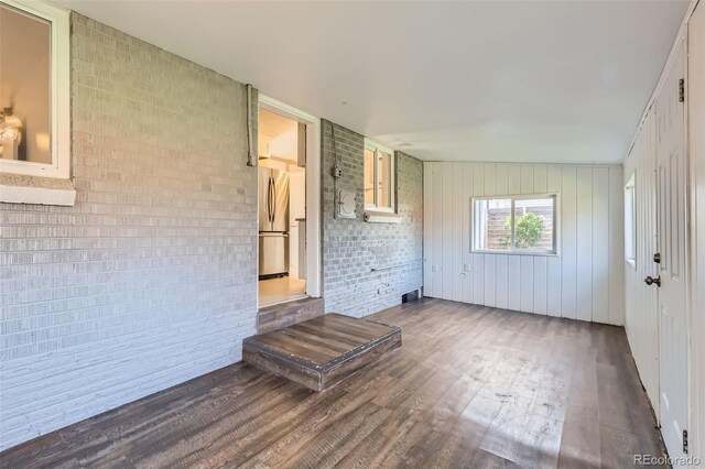 3075 Fairfax St, Denver, CO 80207 - empty room featuring wood finished floors and brick wall