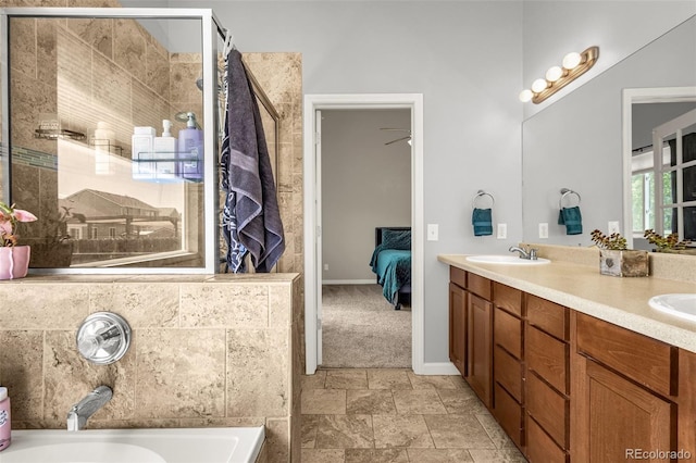 878 Candlestar Loop, Fountain, CO 80817 - full bath with a bath, double vanity, stone finish floors, ensuite bathroom, and baseboards
