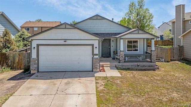 878 Candlestar Loop, Fountain, CO 80817 - view of front of house featuring concrete driveway, covered porch, and a garage