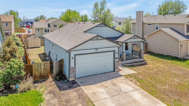 878 Candlestar Loop, Fountain, CO 80817 - view of front of house featuring a residential view, concrete driveway, an attached garage, and stone siding