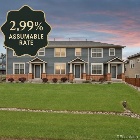 8237 W 54th Ave Unit 2, Arvada, CO 80002 - view of front of property with brick siding and a front lawn
