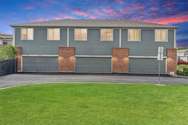 8237 W 54th Ave Unit 2, Arvada, CO 80002 - townhome / multi-family property featuring a garage, driveway, a front yard, and a shingled roof