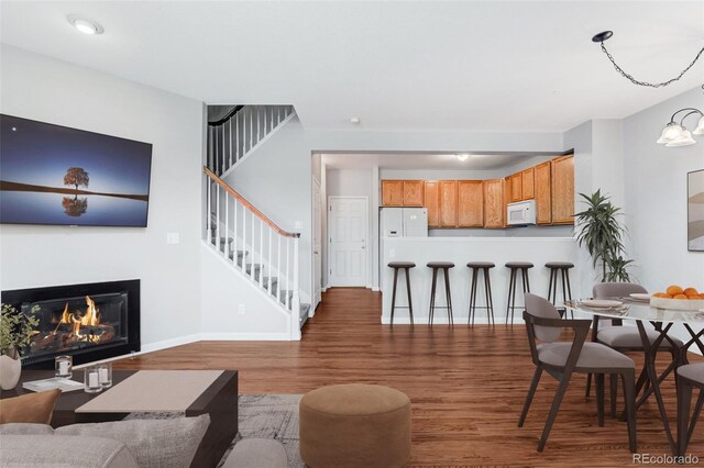 8237 W 54th Ave Unit 2, Arvada, CO 80002 - living room featuring stairway, wood finished floors, and a glass covered fireplace