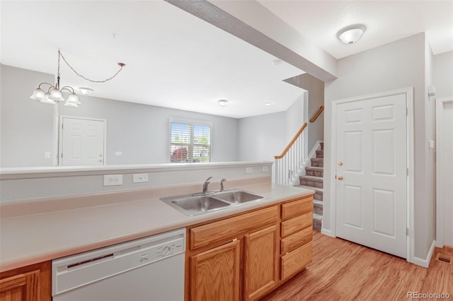 8237 W 54th Ave Unit 2, Arvada, CO 80002 - kitchen with dishwasher, light wood-style floors, light countertops, and a chandelier