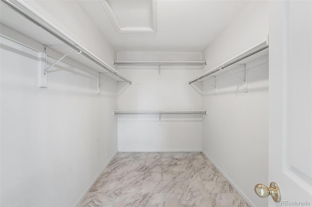 8237 W 54th Ave Unit 2, Arvada, CO 80002 - spacious closet featuring marble look tile flooring and attic access