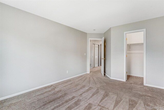 8237 W 54th Ave Unit 2, Arvada, CO 80002 - unfurnished bedroom featuring carpet floors, a walk in closet, and a closet