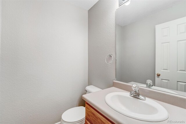 8237 W 54th Ave Unit 2, Arvada, CO 80002 - bathroom featuring vanity and a textured wall