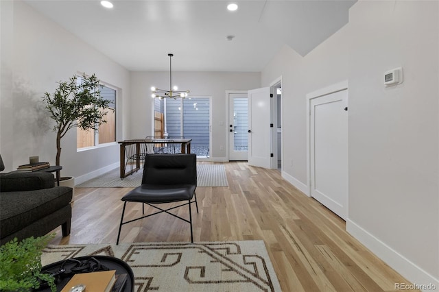 corridor featuring light hardwood / wood-style floors and a chandelier