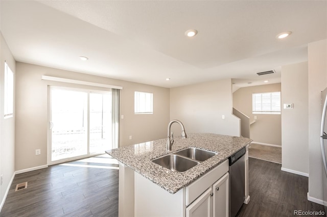 kitchen featuring stainless steel dishwasher, dark wood finished floors, visible vents, and a sink