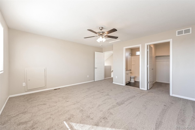 unfurnished bedroom with visible vents, baseboards, connected bathroom, and carpet flooring